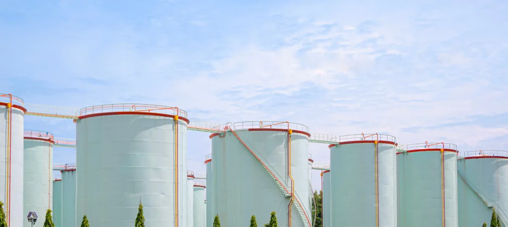 White chemical process safety tanks in front a of blue sky
