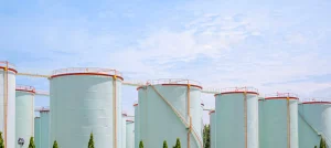 White chemical process safety tanks in front a of blue sky