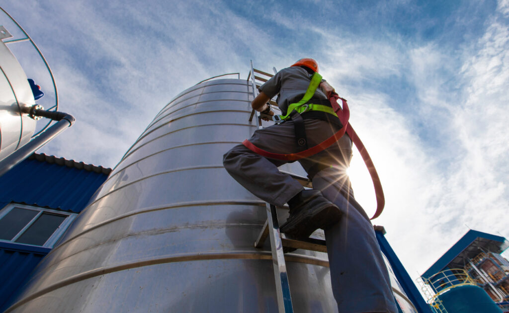 Man inspecting a tank for Predictive Maintenance